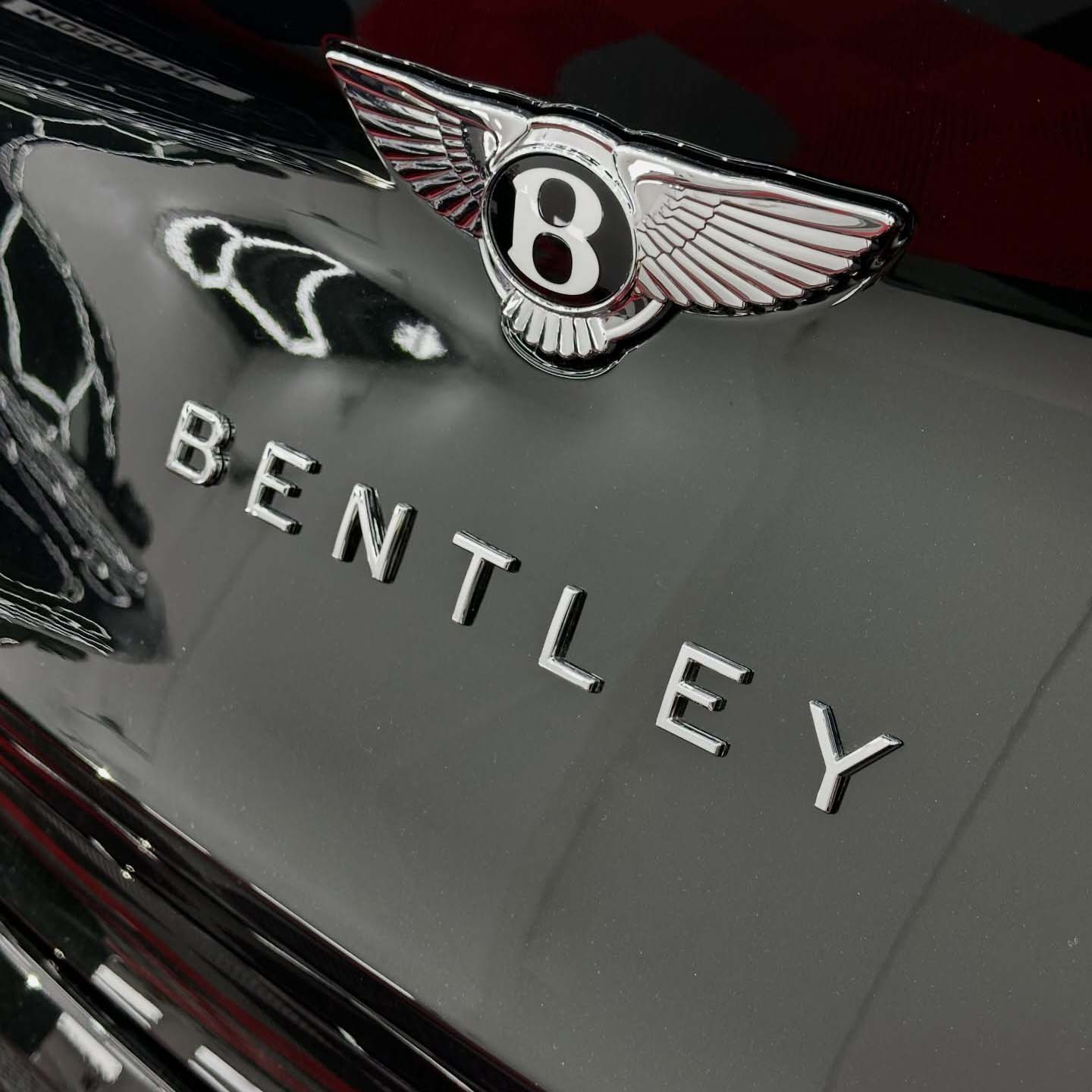Close up of Bentley car badge on back of car